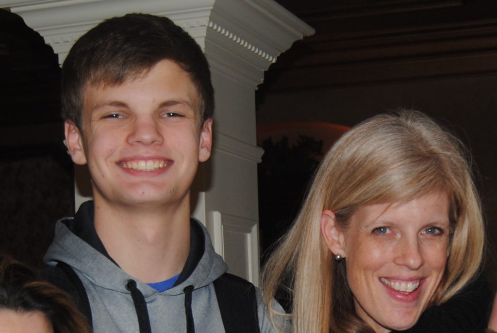 Image of Erin Gallagher and her son, Jay, looking at the camera and smiling for a photo.